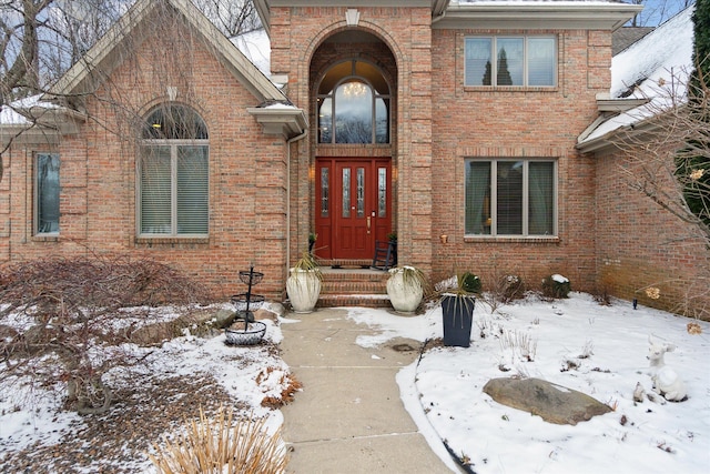 snow covered property entrance with french doors