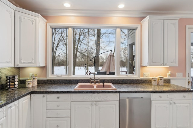 kitchen featuring decorative backsplash, crown molding, sink, and white cabinets