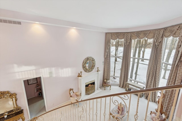 interior space with a fireplace with flush hearth and visible vents