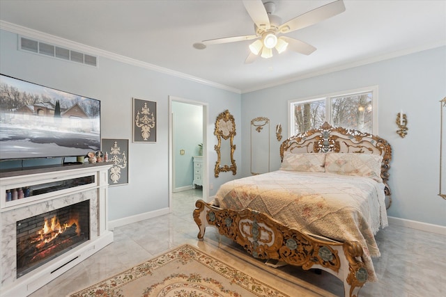 bedroom with ceiling fan, ornamental molding, and a premium fireplace