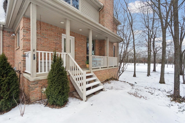 view of snow covered exterior with covered porch