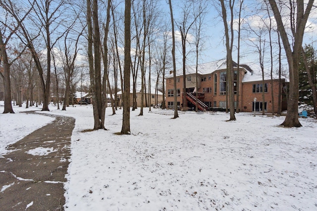 yard covered in snow with stairs