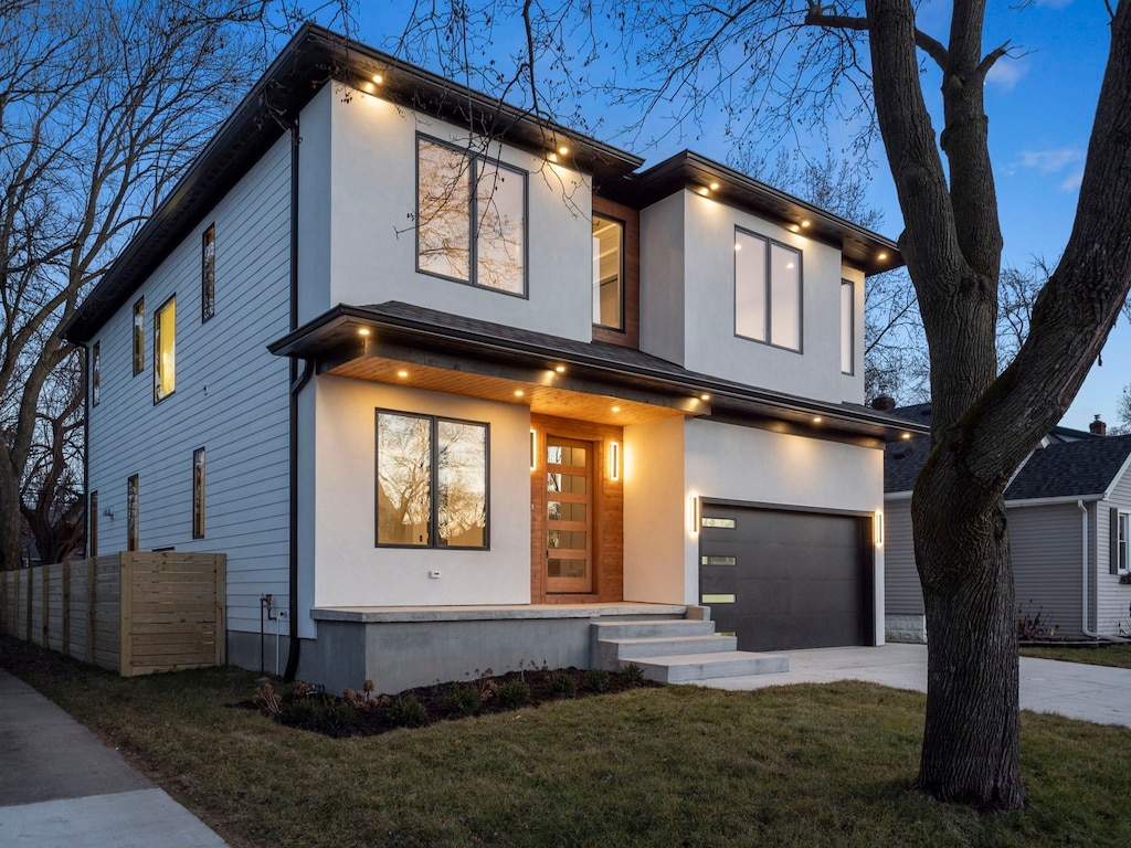 modern home with a garage and a front lawn