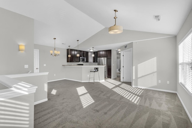 unfurnished living room with carpet flooring, lofted ceiling, and a chandelier