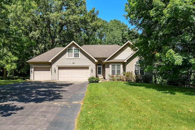 view of front of home featuring a garage and a front lawn