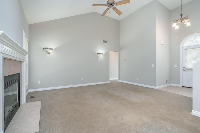 8816 Hathaway Rd, Kalamazoo, MI 49009 - unfurnished living room featuring high vaulted ceiling, visible vents, a fireplace, ceiling fan with notable chandelier, and light colored carpet
