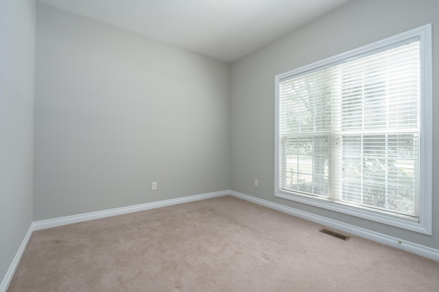 8816 Hathaway Rd, Kalamazoo, MI 49009 - spare room with baseboards, visible vents, and light colored carpet
