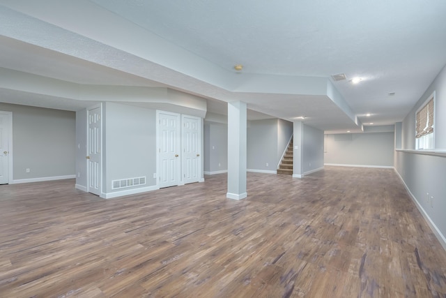 8816 Hathaway Rd, Kalamazoo, MI 49009 - finished basement featuring baseboards, stairs, visible vents, and wood finished floors