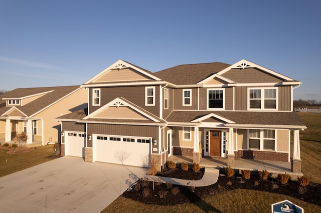 craftsman house with a front yard and a garage