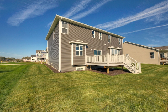 back of house featuring a deck and a lawn