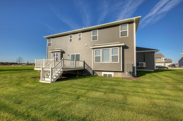 rear view of property featuring a yard and a wooden deck