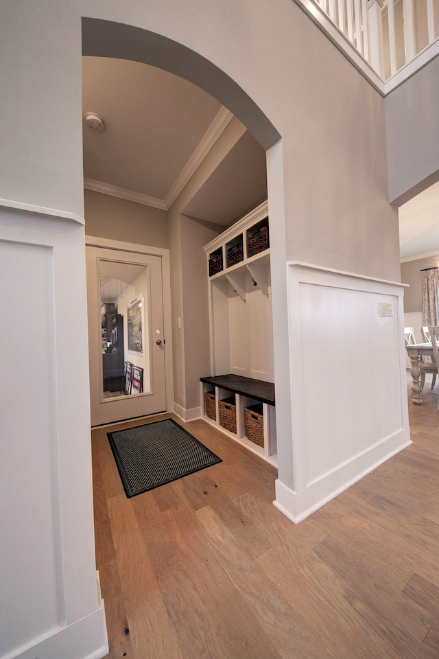 mudroom with hardwood / wood-style floors and crown molding