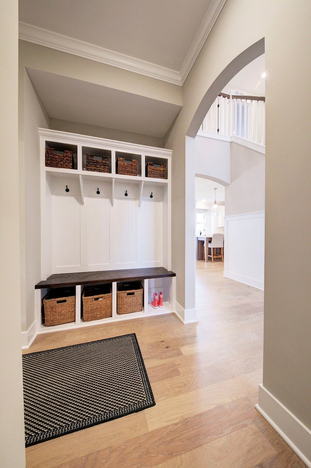 mudroom featuring crown molding and wood-type flooring