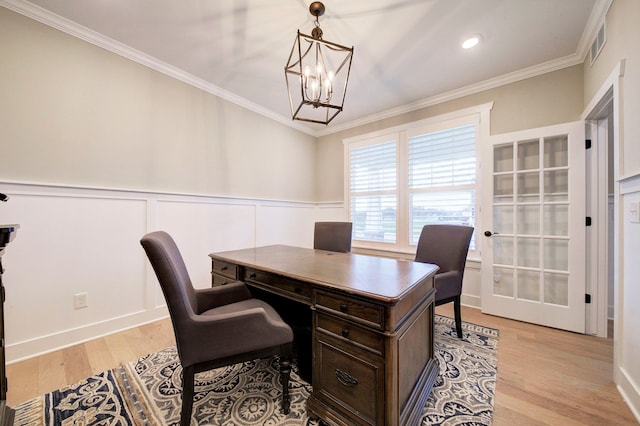 office space featuring a notable chandelier, light hardwood / wood-style floors, and crown molding