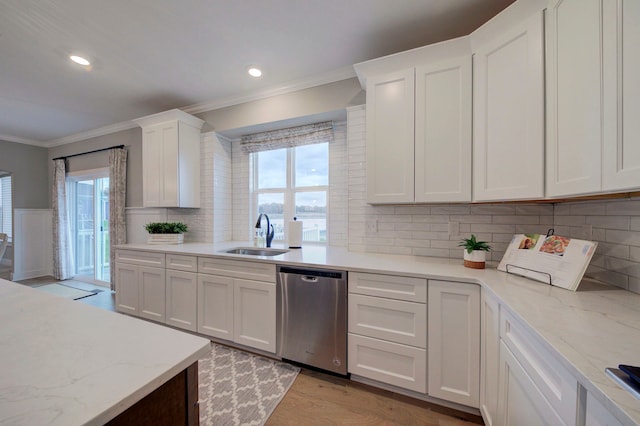 kitchen featuring dishwasher, white cabinets, and sink