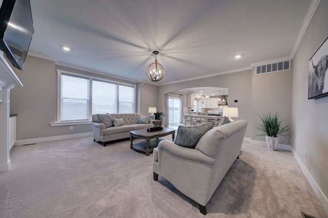 living room with a notable chandelier, light colored carpet, and crown molding