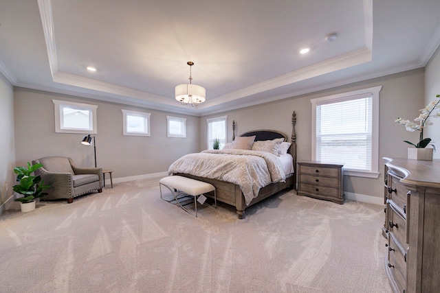 carpeted bedroom featuring a raised ceiling, multiple windows, and ornamental molding