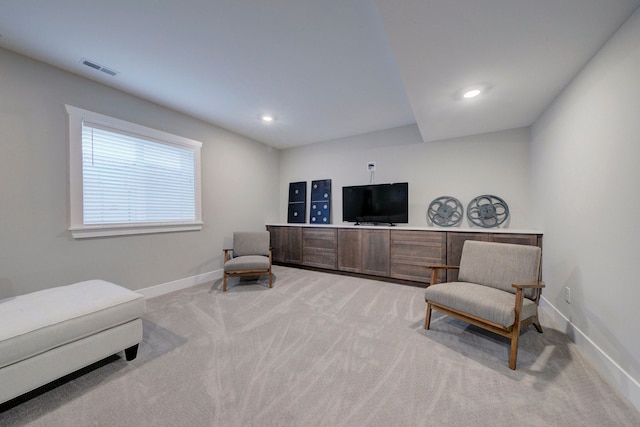 living area featuring light colored carpet