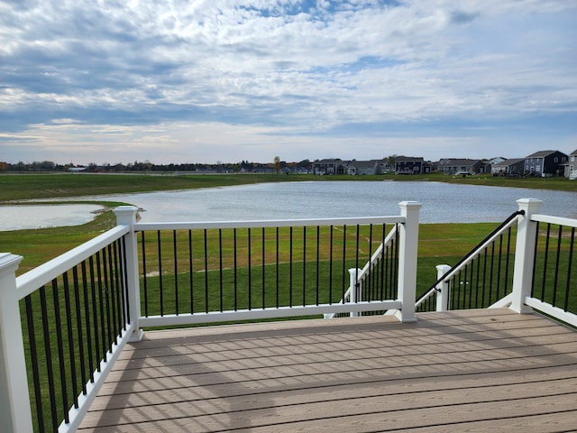 deck featuring a yard and a water view