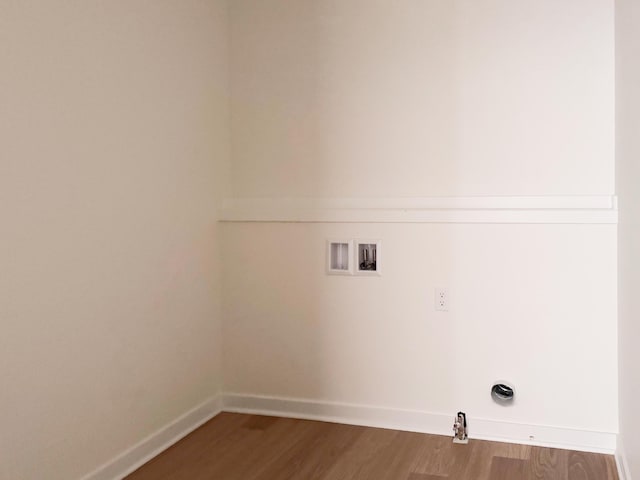 clothes washing area with hardwood / wood-style flooring and washer hookup