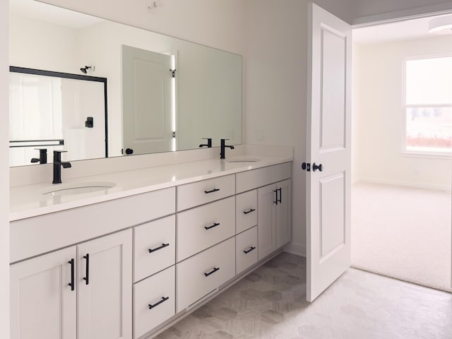 bathroom with vanity and a shower with shower door