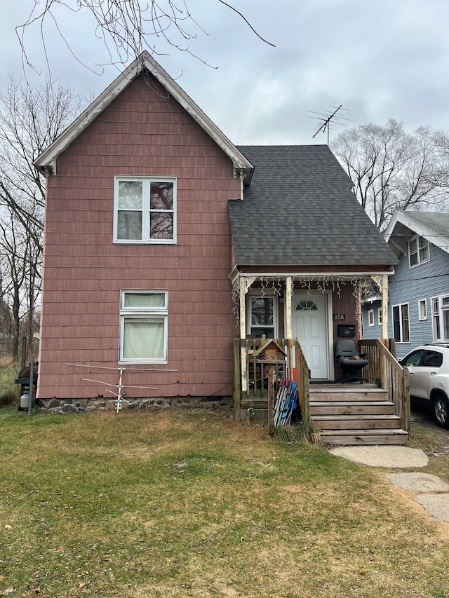 back of house with a lawn