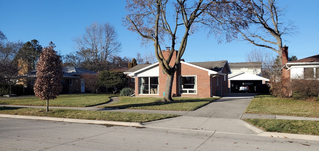 single story home with a garage and a front lawn