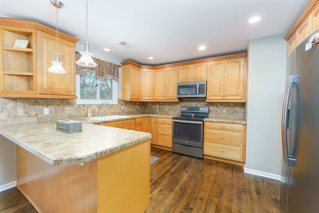 kitchen with dark wood-type flooring, sink, hanging light fixtures, kitchen peninsula, and stainless steel appliances