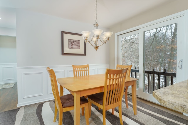 dining space with an inviting chandelier