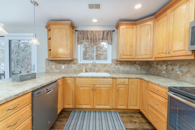 kitchen with appliances with stainless steel finishes, tasteful backsplash, dark wood-type flooring, sink, and pendant lighting