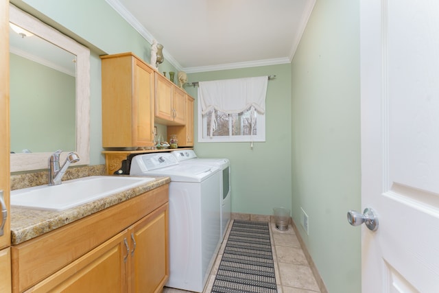 laundry area with sink, cabinets, washer and clothes dryer, light tile patterned flooring, and ornamental molding