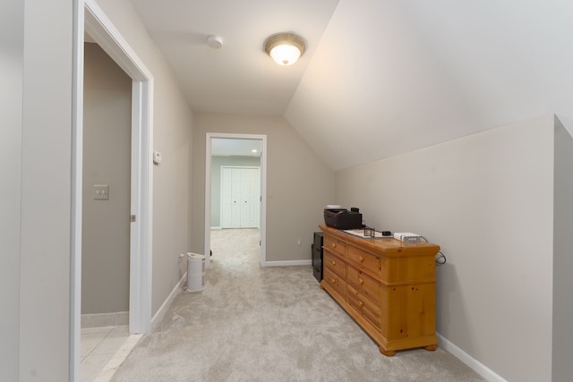 interior space featuring light colored carpet and vaulted ceiling