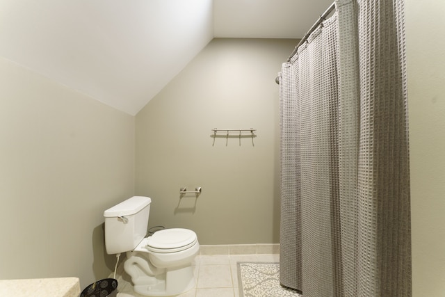 bathroom featuring tile patterned flooring, toilet, and vaulted ceiling