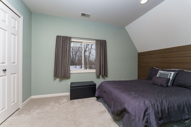 carpeted bedroom with vaulted ceiling