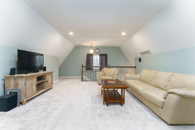 carpeted living room featuring lofted ceiling