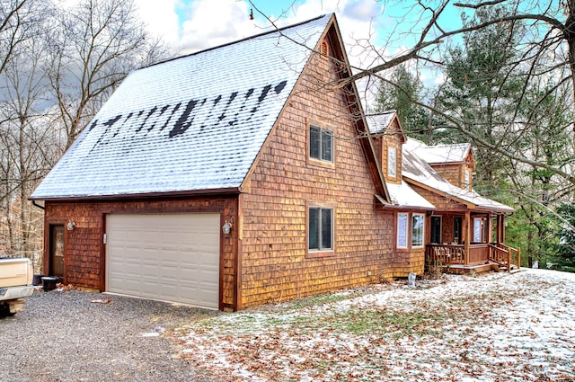 snow covered property featuring a garage