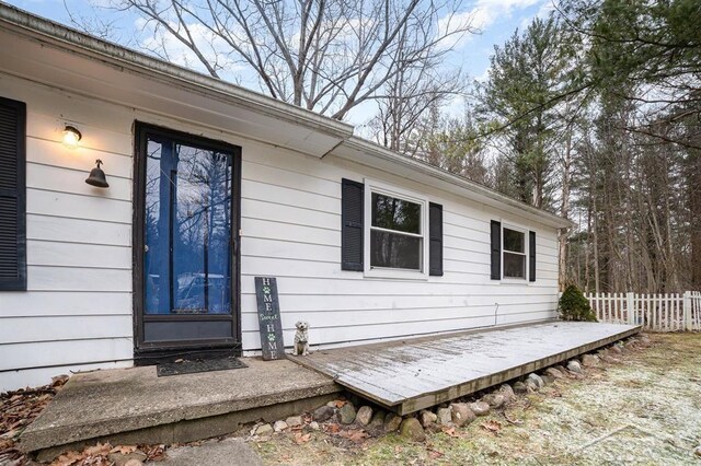 view of exterior entry with a deck