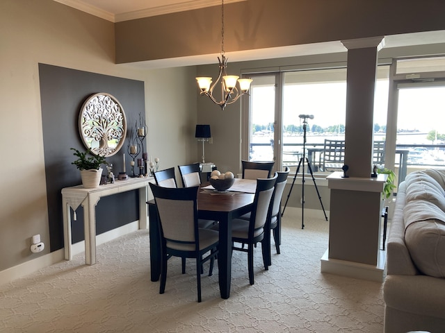 dining area with crown molding, light carpet, and an inviting chandelier