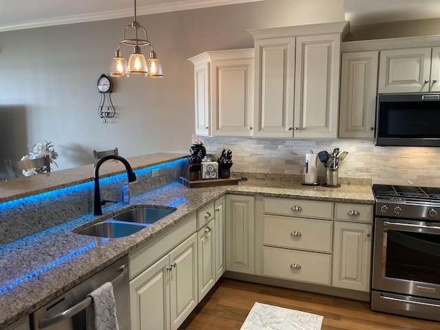 kitchen featuring tasteful backsplash, light stone countertops, sink, and appliances with stainless steel finishes