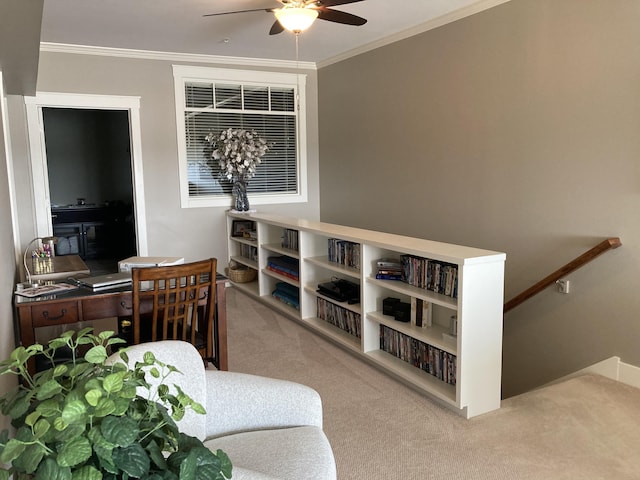 carpeted office space featuring ceiling fan and crown molding