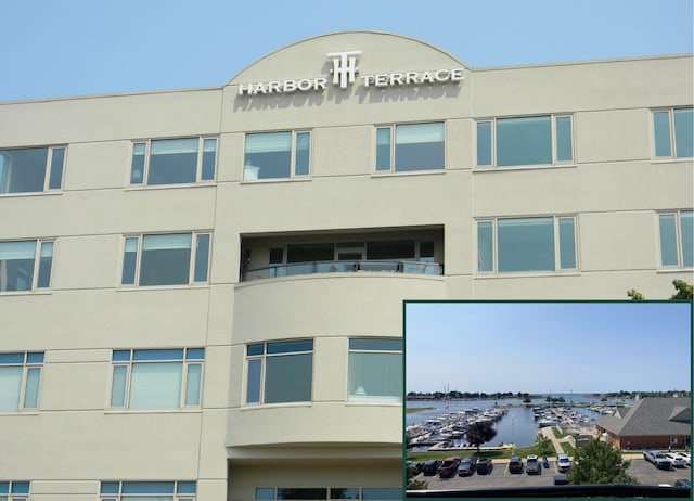 105 W Danaher St Unit 401, Ludington, MI 49431 - view of apartment building / complex featuring view of marina