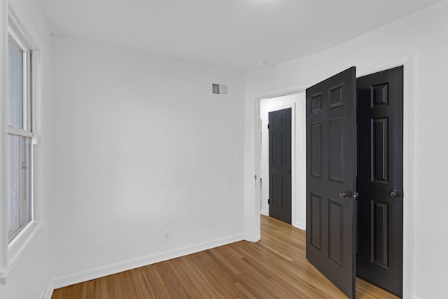 spare room with light hardwood / wood-style flooring