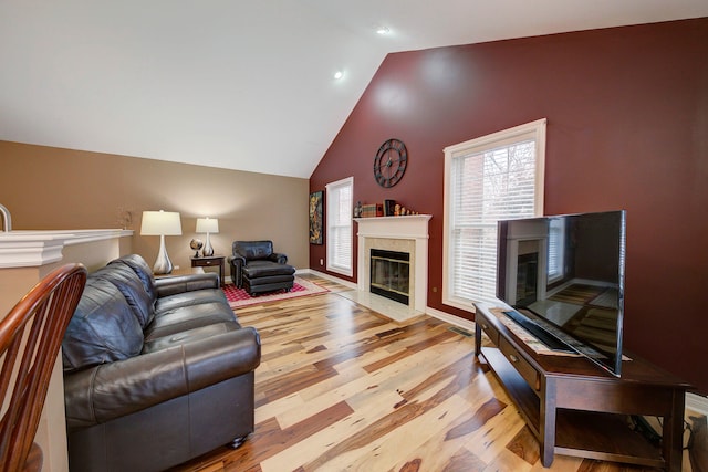 living room featuring lofted ceiling and light wood-type flooring