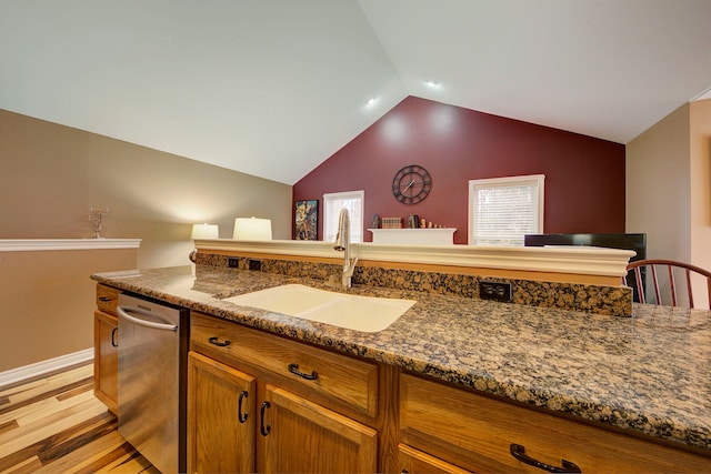 kitchen with light wood-type flooring, sink, stone countertops, dishwasher, and lofted ceiling