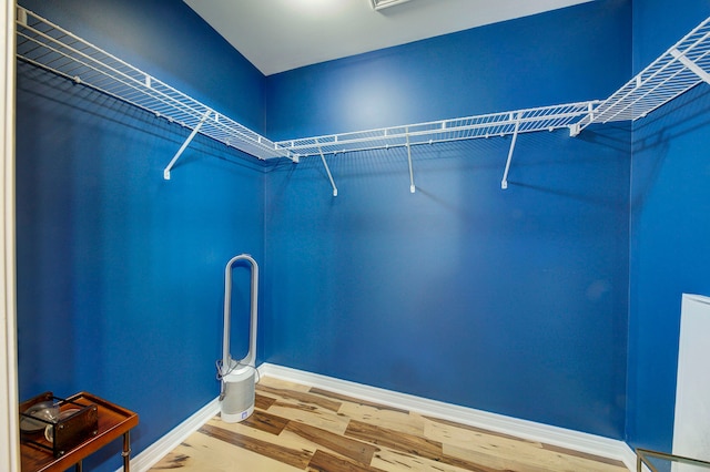 spacious closet featuring hardwood / wood-style floors