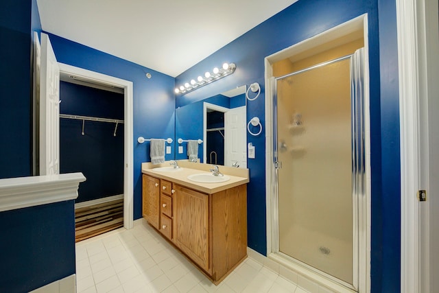 bathroom with vanity, tile patterned floors, and a shower with door