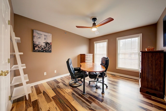 office with ceiling fan and light hardwood / wood-style flooring