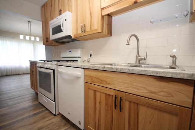 kitchen featuring tasteful backsplash, dark hardwood / wood-style flooring, sink, and white appliances