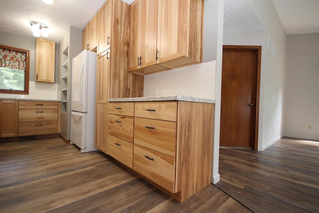 kitchen featuring decorative backsplash, light brown cabinets, white refrigerator, and dark wood-type flooring