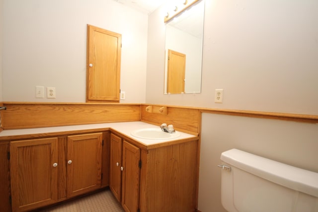 bathroom featuring tile patterned floors, vanity, and toilet